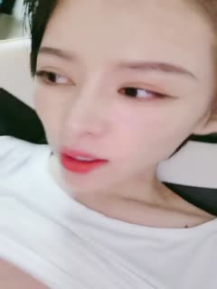 Short-haired cool and neutral girl with thin waist and long legs masturbates and lifts up her clothes to squeeze her tits and spread her legs to open her pussy. Close-up of taking out a glass stick and cucumber in and out