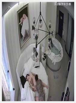 Luxury suite candid shot of tall, fair-skinned, beautiful lady with back tattoos...